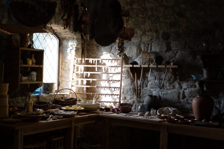 Stone kitchen interior with window light, tools and domestic objects