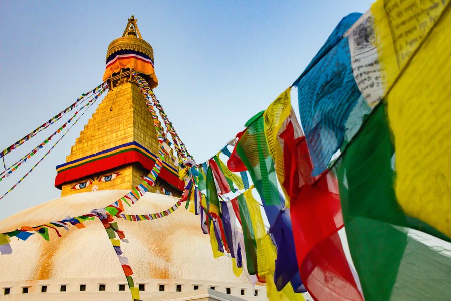 Boudha Stupa with colorful prayer flags crossing the frame