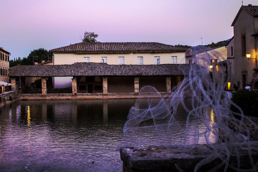 Waterfront scene at violet dusk with a translucent net in the foreground