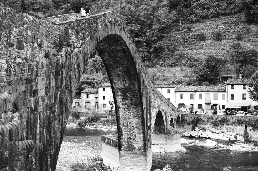 Black and white stone bridge crossing a river
